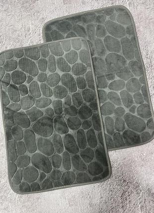 Дві сірих килимки у ванну камінці