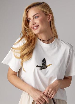 Трикотажна футболка прикрашена птицею зі стразів — молочний колір, l (є розміри)
