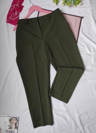 Стильные брюки зеленые по фигуре с карманами укороченные к низу брюки с строчками классические штанишки хаки