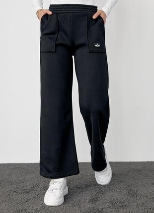 Жіночі штани широкі  на флісі теплі  трикотажні зимові з накладними кишенями 3-нитка чорний колір s m