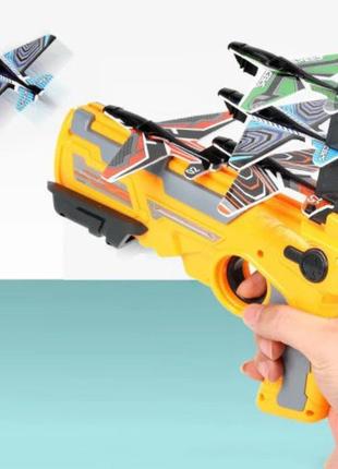 Дитячий іграшковий пістолет з літачками air battle катапульта з літаючими літаками (ab-1). колір: жовтий