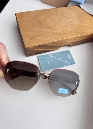 Фирменные солнцезащитные безоправные очки rita bradley polarized rb90264 фото
