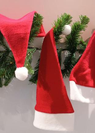 Новорічні флісові червоні шапки ковпаки для дорослих та дітей 54 та 56 см