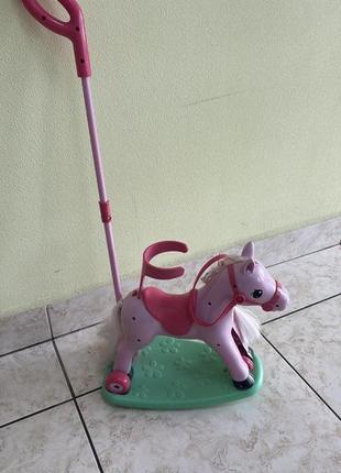 Игрушка каталка розовая лошадка.
