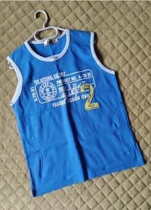 Майка на 10-12 років,плечі 33,5 см,підмишки 41 см,довжина 55 см .