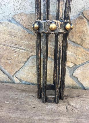 Кованый средневековый бра ручной работы на фоне средневекового фонаря (факела)