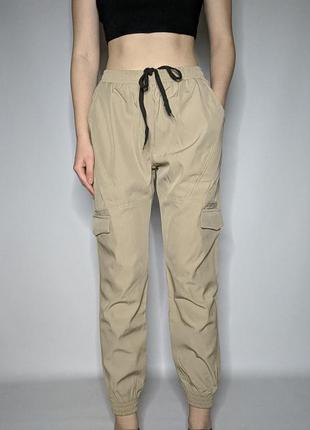 Песочные бежевые джогеры карго брюки штаны с карманами на резинках манжетах
