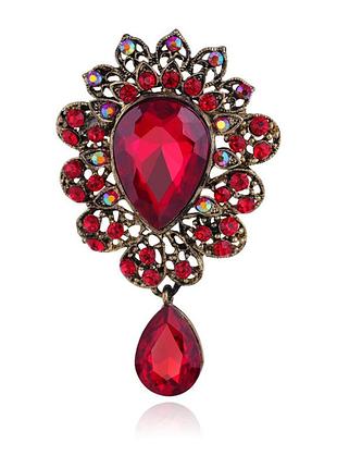 Брошка бронзового кольору з темним бордовим , червоним, чорним каменем