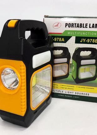 Портативний ліхтар лампа jy-978b акумуляторний із сонячною панеллю + power bank. колір жовтий2 фото