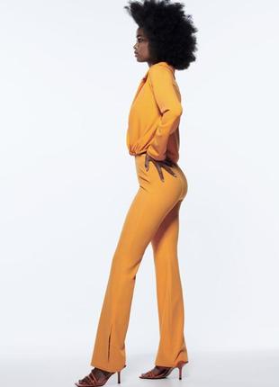 Жіночі помаранчеві брюки з розрізом зара zara 7901/1675 фото