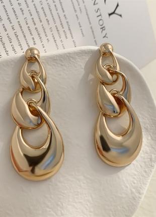 Модні металеві золотисті та сріблясті сережки