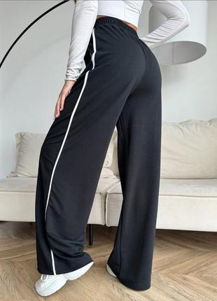 Черные широкие брюки с боковыми тесемками4 фото