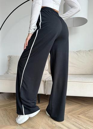 Чорні широкі штани з бічними тасьмами4 фото