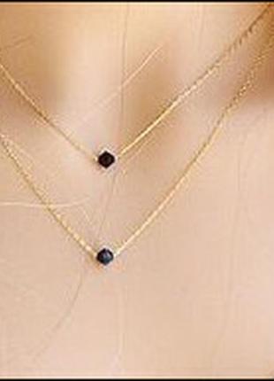 Двошаровий ланцюжок золотистого кольору з чорними пластиковими камінцями