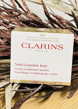 Оригінал денний омолоджувальний крем clarins nutri-lumière day cream