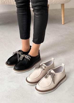 Бежевые и чёрные женские туфли на шнурках на белой низкой подошве