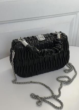 Чорна клатч-сумка з екошкіри, тверда, зі срібною фурнітурою.