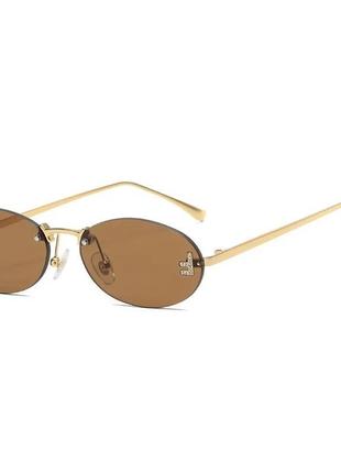 Тренд стильні жіночі коричневі овальні сонцезахисні окуляри сонячні очки металева оправа3 фото