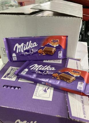 Шоколад молочний milka, зі шматочками карамелі з мигдалем 100 гр.