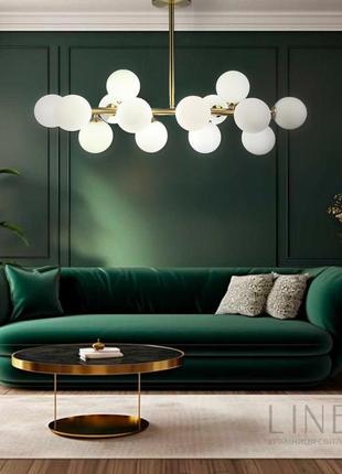 Золота видовжена люстра на 14 білих плафонів