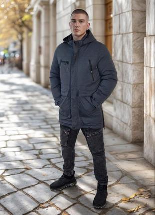 Зимняя удлиненная куртка на молнии с кнопками с капюшоном с карманами