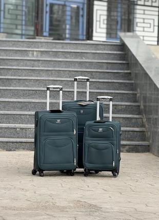 Середня валіза дорожня тканинна m польща на колесах wings з підшипником