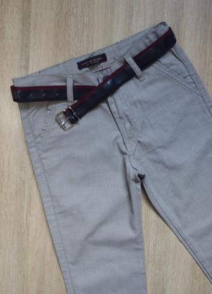 Оригинальные светлые брюки с ремнем1 фото