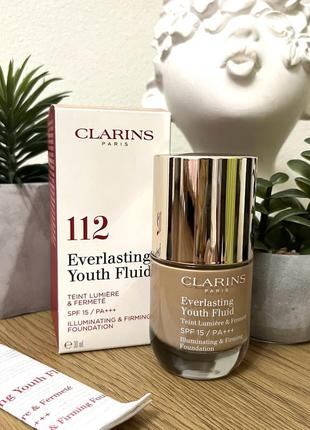 Оригинальный clarins everlasting youth fluid устойчивый тональный флюид с омолаживающим действием, spf 15 112 amber оригинал стоекий тональной флюид крем