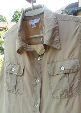 Спортивного стиля шелковая блузка с карманами без рукавов. швейцария.