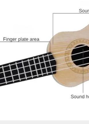 Гітара дитяча іграшка, коричнева, дитяча укулеле, довжина - 25см, ширина 9см, пластик, 4 струни, унісекс, 3+9 фото