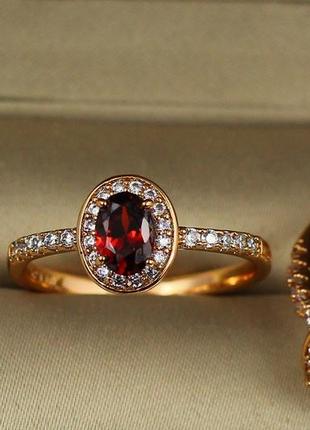 Кольцо xuping jewelry красный овальный фианит в кругу белых камней р 20  золотистое