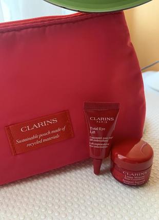 Косметичка clarins и мини крема для глаз