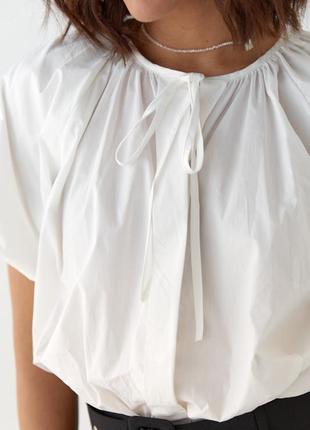 Блузка оверсайз с завязками и короткими рукавами5 фото