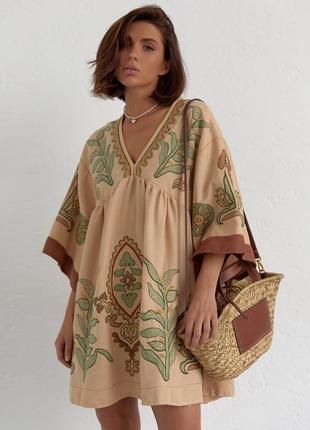 Сукня вишиванка а-силуету. виріб із глибоким v-подібним вирізом горловини. широкі рукави зі спущеною