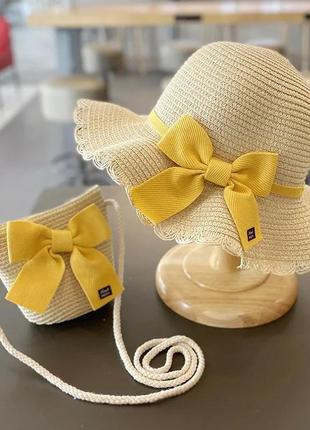 Комплект дитячий сонцезахисний солом'яний капелюх канотьє та солом'яний сумочка кольору бежевий декор жовтий бант