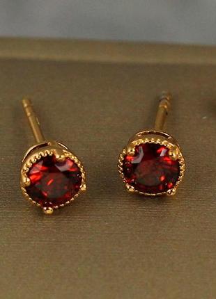 Серьги гвоздики  xuping jewelry красный фианит в ободке из точек 5 мм золотистые1 фото