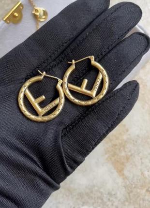 Сережки кульчики брендові золоті в стилі fendi фенді кільця