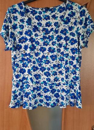 Стрейчевая фктболка с ярким цветочным принтом. на бедрах расширения, которая очень красиво ложится пофигуре. будет идеально лежать на 16 и на 18 размере.