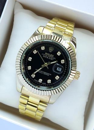 Чоловічий наручний годинник на браслеті золотистого кольору з чорним циферблатом1 фото