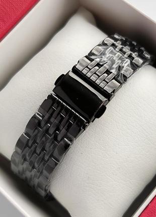 Жіночий наручний годинник чорного кольору із циферблатом що обертається та камінчиками навколо4 фото