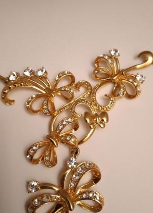 Набор бижутерии колье  ожерелье  и серьги с кристаллами бантики цвета золота7 фото