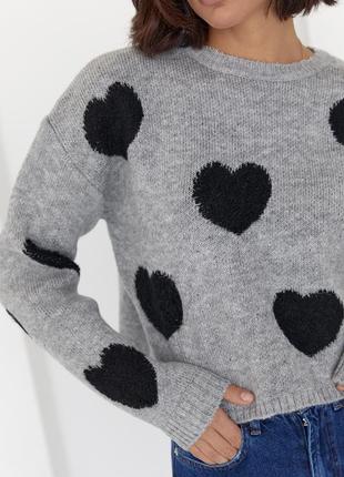 Жіночий в'язаний светр оверсайз з сердечками.2 фото