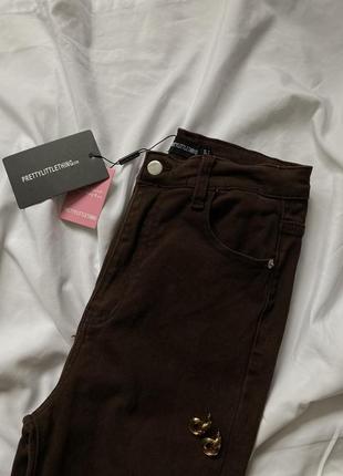 Коричневі еластичні джинси кльош від коліна4 фото