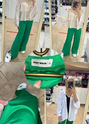 Широкі атласні штани з розрізами внизу на коло швах яскравого зеленого кольору1 фото
