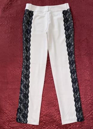 Дизайнерські штани з ажурними вставками по бокам від андре тану3 фото
