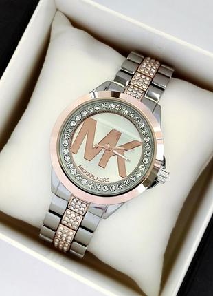 Жіночий наручний годинник комбінованого кольору з камінчиками