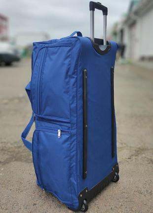 Дорожная тканевая сумка на колесах 130 л синяя с ручкой