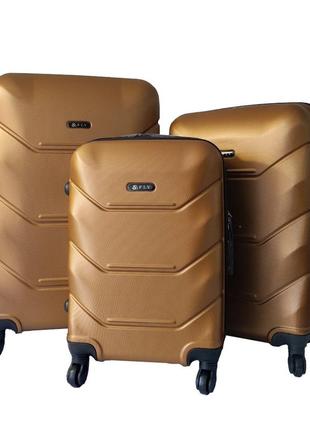 Набір дорожніх валіз fly 2019 abs пластик 4-колеса набір 3шт l/m/s бронзовий1 фото