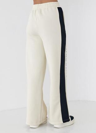 Теплые женские трикотажные брюки с лампами и надписью renes saince.10 фото