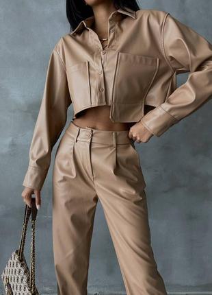Стильний шкіряний костюм утеплений жакет сорочка вкорочена асиметрична х кишенями на ґудзиках штани з високою посадкою широкі кльош модний трендовий3 фото